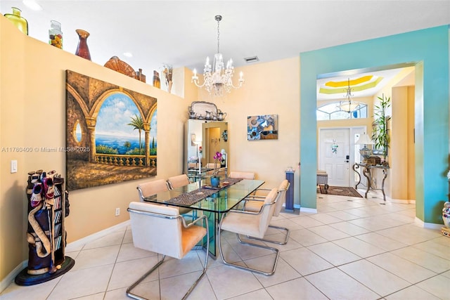 dining space with tile patterned floors, visible vents, baseboards, and an inviting chandelier