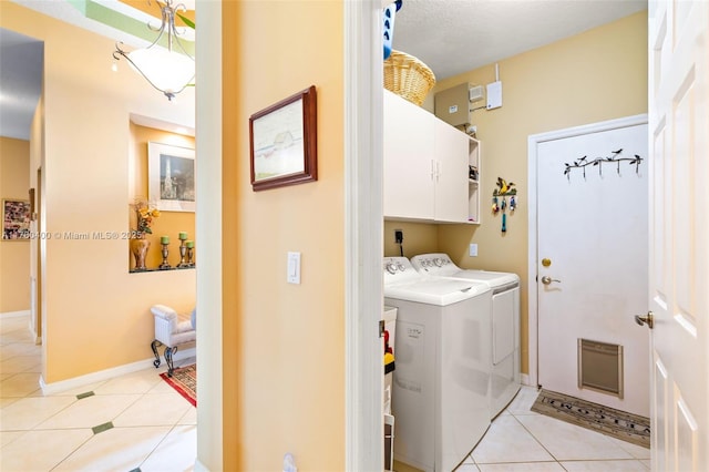laundry room with washer and dryer, light tile patterned flooring, baseboards, and cabinet space