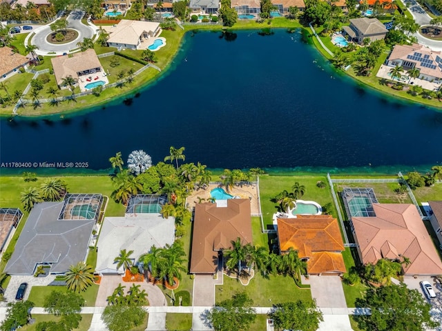 drone / aerial view with a water view and a residential view