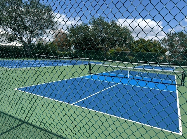 view of sport court featuring fence