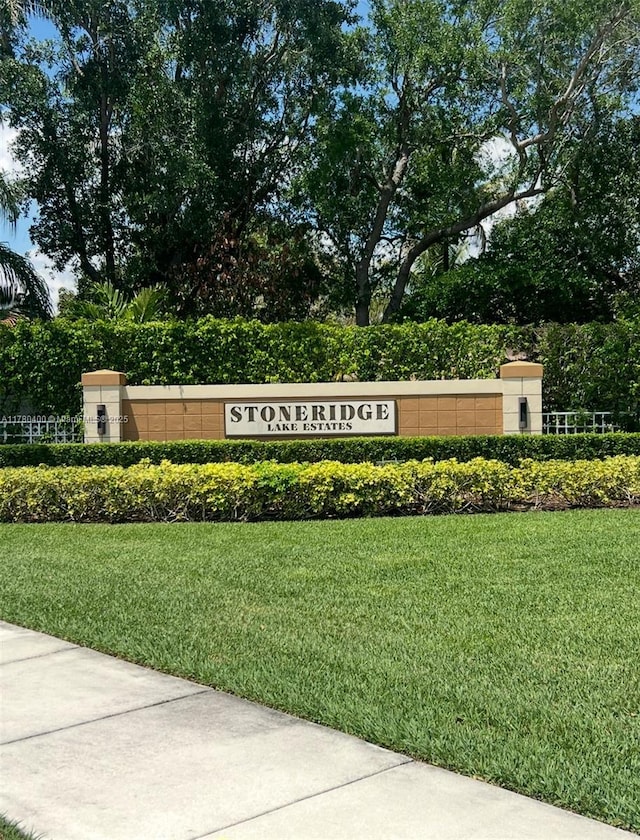 community sign featuring a lawn