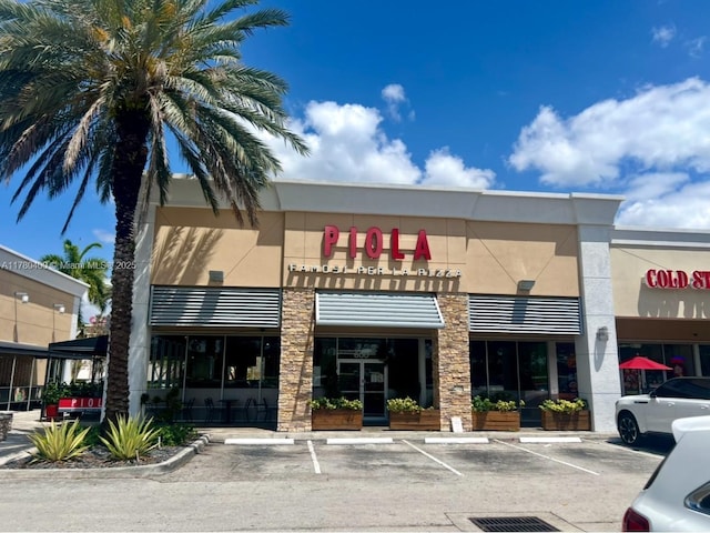 view of building exterior featuring uncovered parking