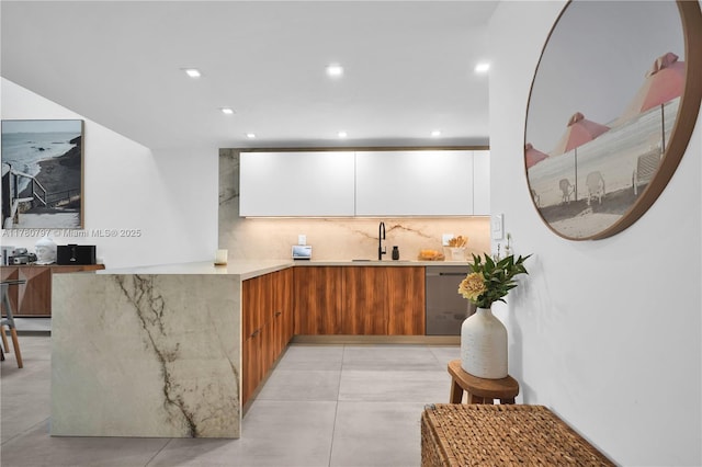 311 Poinciana Dr Unit 801, Sunny Isles Beach, FL 33160 - kitchen featuring modern cabinets, a sink, brown cabinets, backsplash, and stainless steel dishwasher