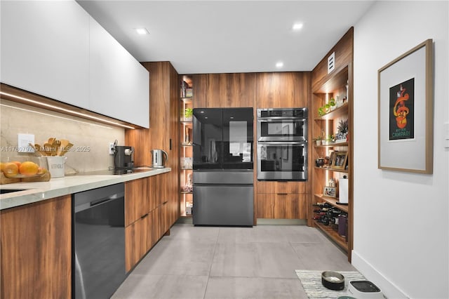 311 Poinciana Dr Unit 801, Sunny Isles Beach, FL 33160 - kitchen with stainless steel appliances, brown cabinets, modern cabinets, and light countertops