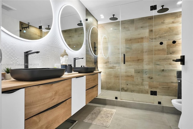 311 Poinciana Dr Unit 801, Sunny Isles Beach, FL 33160 - full bathroom featuring double vanity, visible vents, a sink, and a stall shower