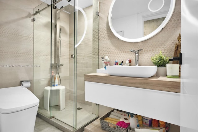 311 Poinciana Dr Unit 801, Sunny Isles Beach, FL 33160 - bathroom featuring toilet, vanity, tile walls, and a stall shower