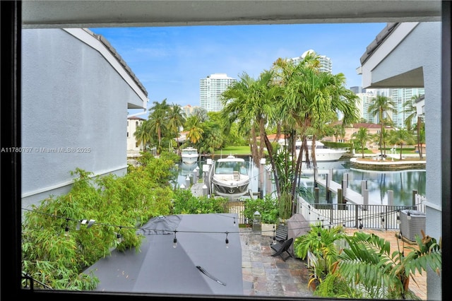 311 Poinciana Dr Unit 801, Sunny Isles Beach, FL 33160 - exterior space featuring central AC unit, outdoor dining area, and a water view