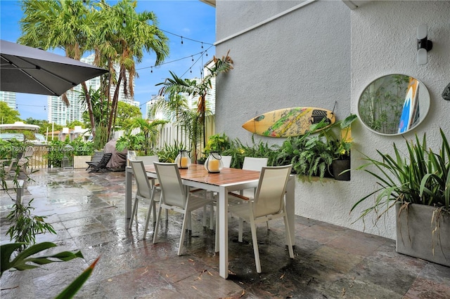 311 Poinciana Dr Unit 801, Sunny Isles Beach, FL 33160 - view of patio / terrace featuring fence and outdoor dining area