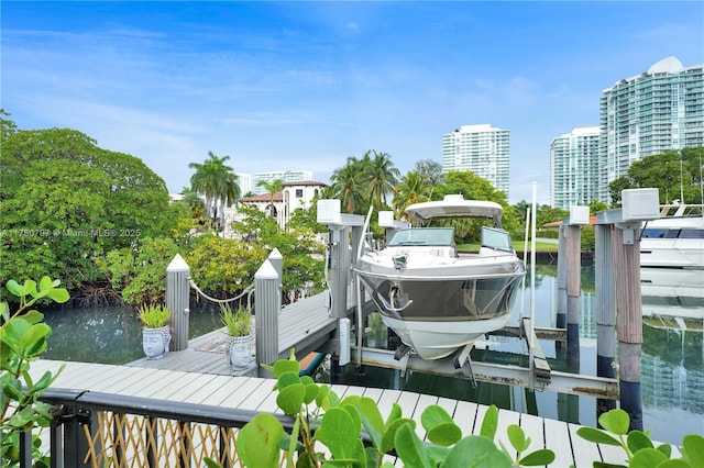 311 Poinciana Dr Unit 801, Sunny Isles Beach, FL 33160 - view of dock featuring a city view, boat lift, and a water view