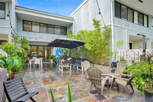 311 Poinciana Dr Unit 801, Sunny Isles Beach, FL 33160 - view of patio / terrace with an outdoor living space with a fire pit