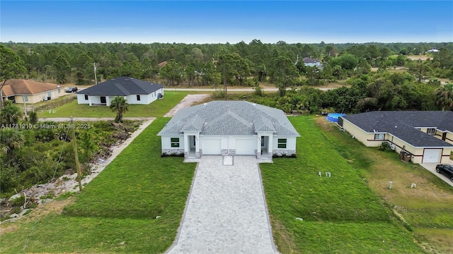 drone / aerial view featuring a wooded view