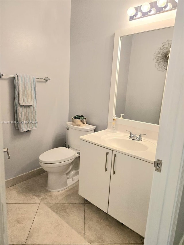bathroom featuring toilet, tile patterned floors, and vanity