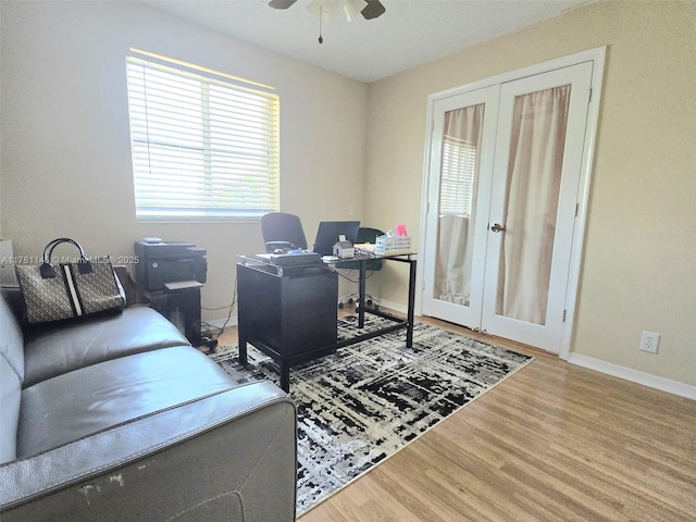 office space featuring french doors, wood finished floors, ceiling fan, and baseboards