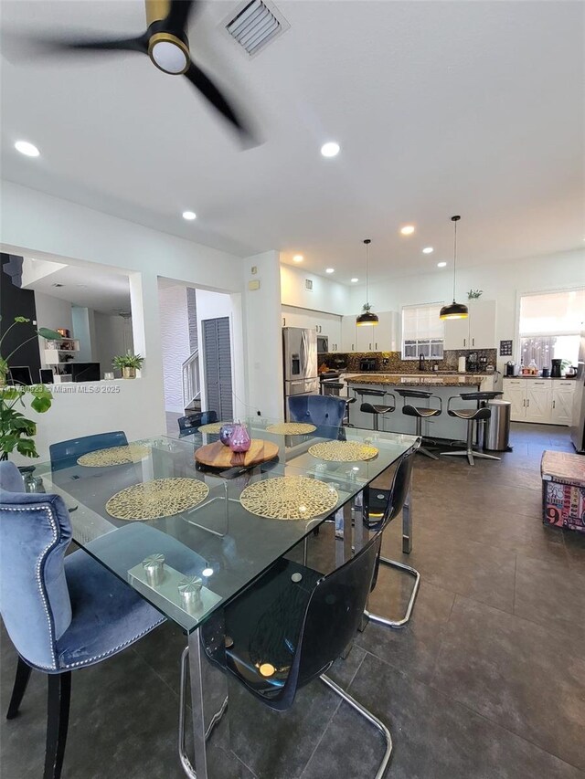 dining room with a ceiling fan, visible vents, and recessed lighting