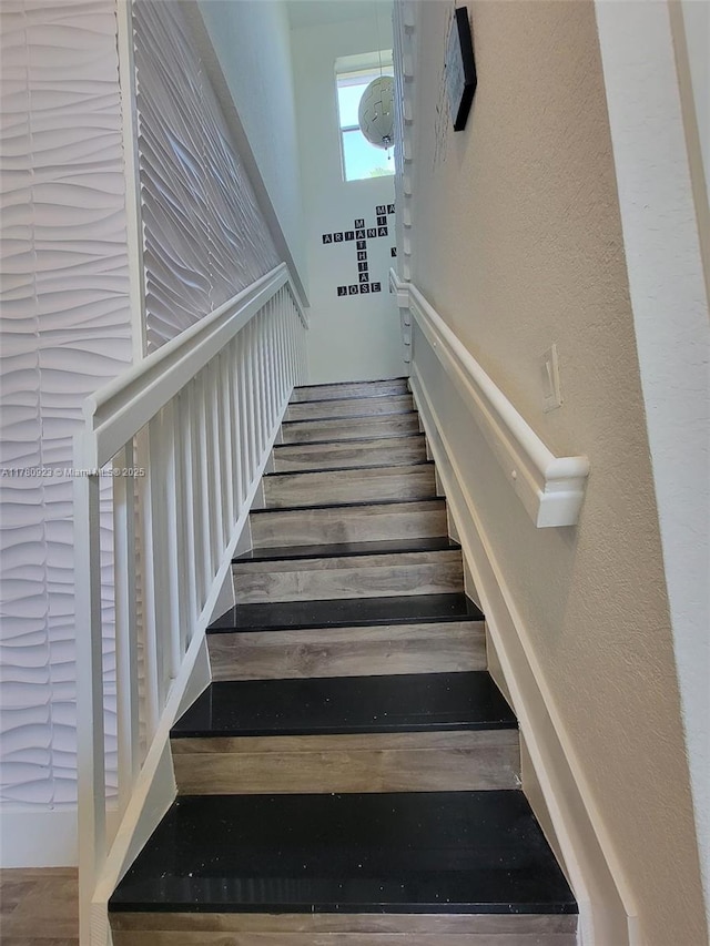 stairway with wood finished floors