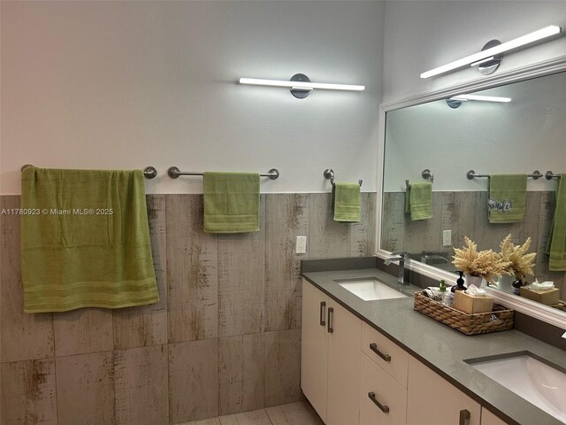 full bath with double vanity and a sink