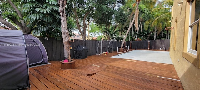 deck with a fenced backyard
