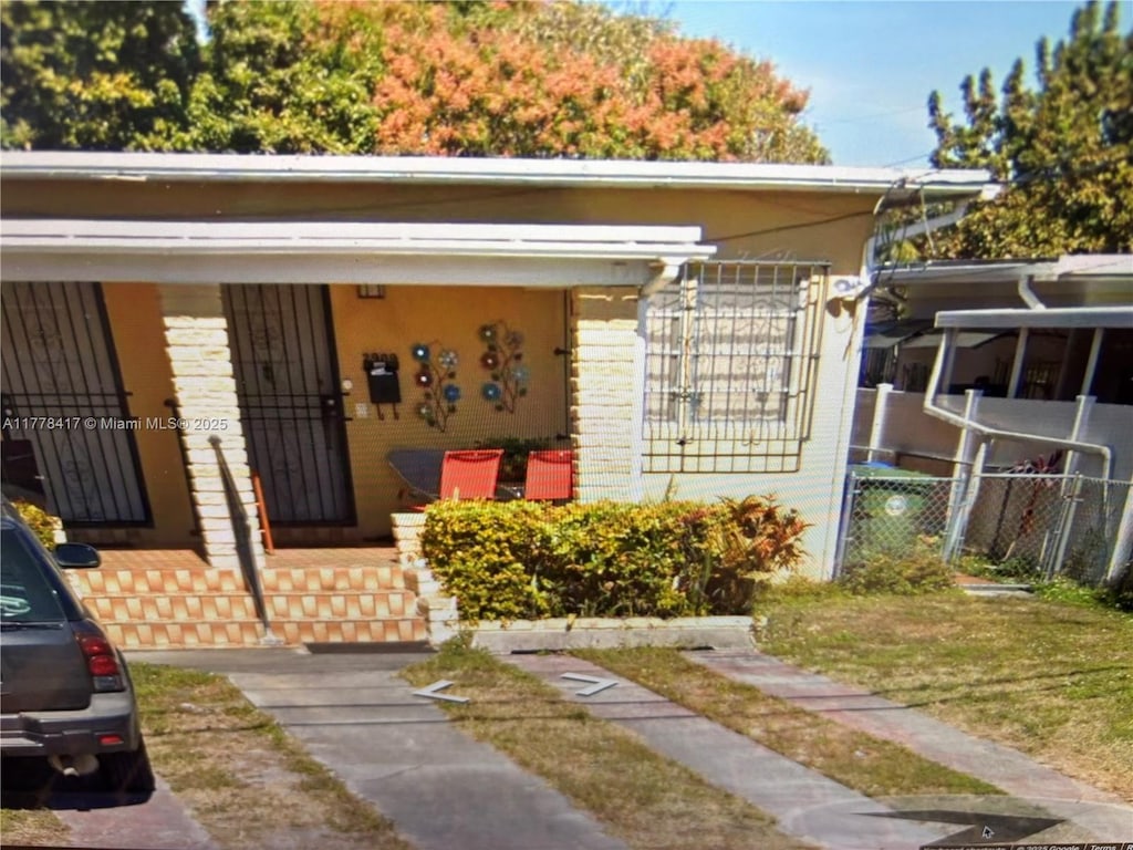 2911 SW 2nd St, Miami, FL 33135 - view of front facade with a porch and brick siding