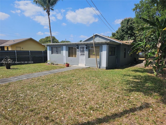 2255 NW 85th St, Miami, FL 33147 - view of front of home with a front yard and fence