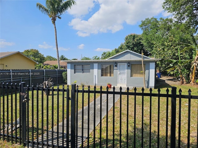 2255 NW 85th St, Miami, FL 33147 - view of front of property featuring a fenced front yard, a front lawn, and a gate