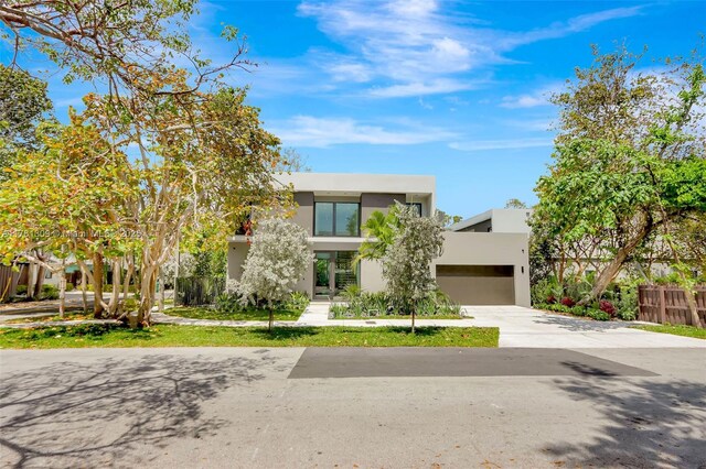 2851 W Trade Ave, Miami, FL 33133 - view of front of property featuring concrete driveway, fence, a garage, and stucco siding