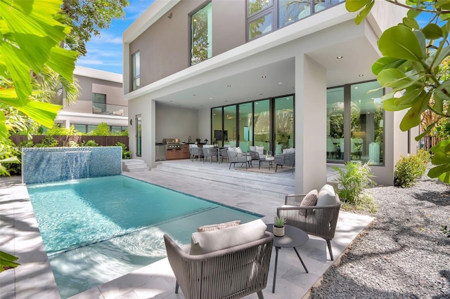 2851 W Trade Ave, Miami, FL 33133 - back of property with a fenced in pool, a patio, stucco siding, and fence