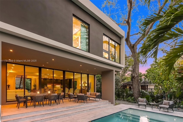 2851 W Trade Ave, Miami, FL 33133 - rear view of house with an outdoor pool, fence, a patio, and stucco siding