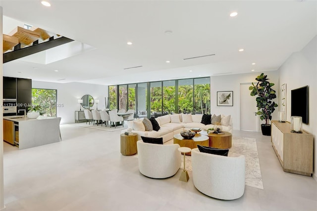 2851 W Trade Ave, Miami, FL 33133 - living area with finished concrete floors, expansive windows, and recessed lighting