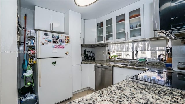 17011 N Bay Rd Unit 701, Sunny Isles Beach, FL 33160 - kitchen featuring freestanding refrigerator, light tile patterned flooring, dark stone counters, dishwasher, and a sink