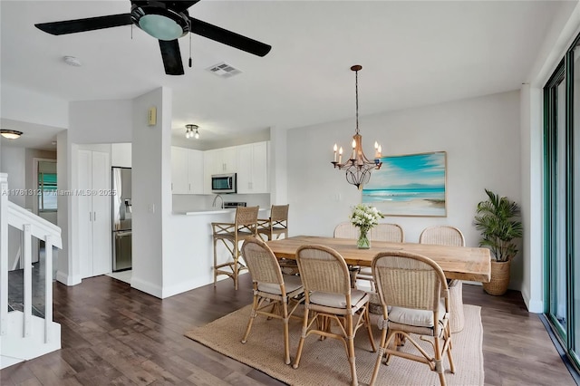 dining room with visible vents, dark wood-type flooring, baseboards, stairs, and ceiling fan with notable chandelier