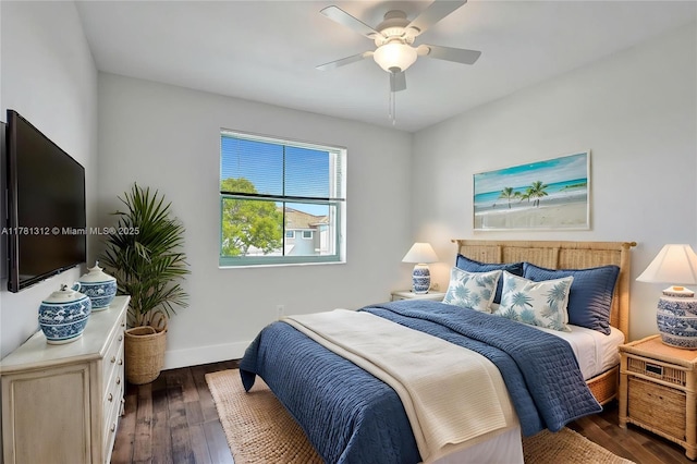 bedroom with ceiling fan, baseboards, and dark wood-type flooring