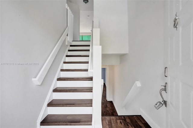 stairs featuring wood finished floors