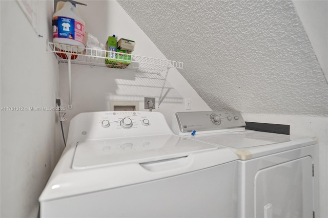 clothes washing area featuring a textured ceiling and independent washer and dryer