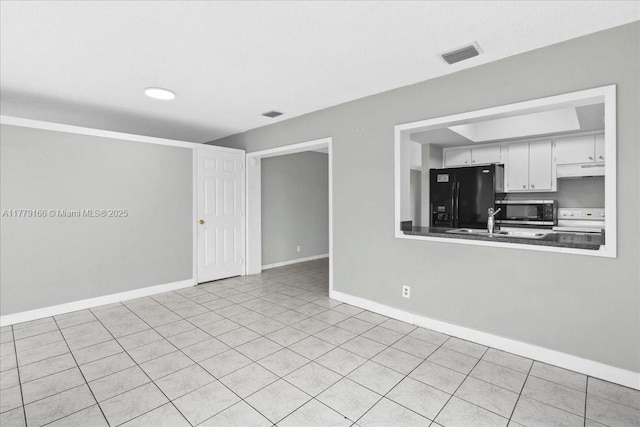 6001 NW 67th Ave, Tamarac, FL 33321 - unfurnished living room with visible vents, baseboards, and tile patterned flooring