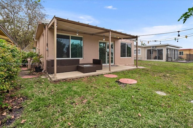 6001 NW 67th Ave, Tamarac, FL 33321 - back of property featuring a sunroom, a patio area, stucco siding, and a lawn