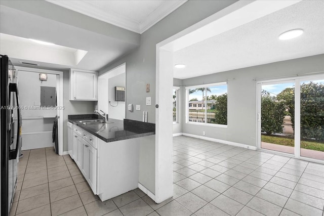 6001 NW 67th Ave, Tamarac, FL 33321 - kitchen featuring black fridge, light tile patterned floors, a sink, and dark countertops