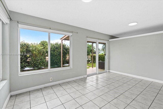 6001 NW 67th Ave, Tamarac, FL 33321 - spare room with light tile patterned floors and baseboards