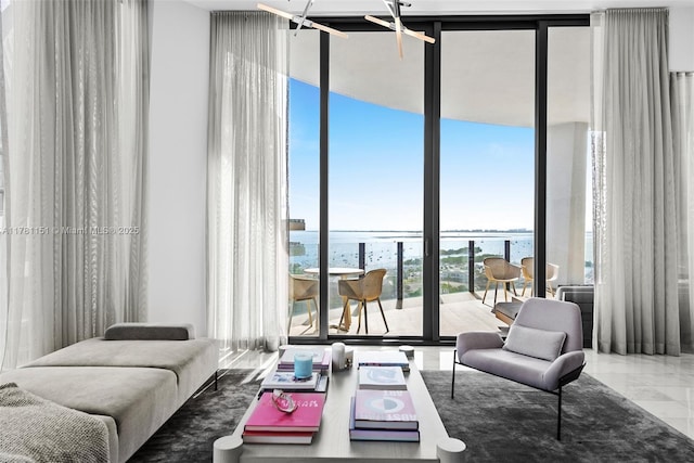 living room with expansive windows, a water view, and marble finish floor