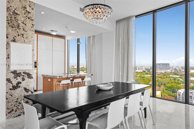 dining space with expansive windows, a notable chandelier, and plenty of natural light