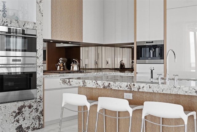 kitchen with modern cabinets, white cabinets, appliances with stainless steel finishes, and a sink