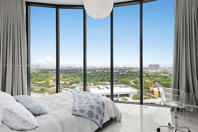bedroom featuring a city view, marble finish floor, and multiple windows