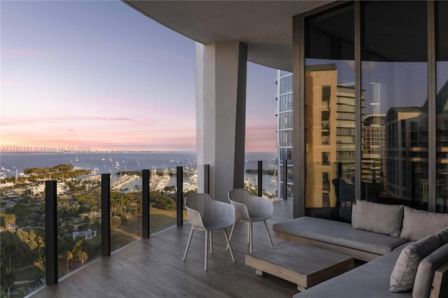 balcony with outdoor lounge area and a water view