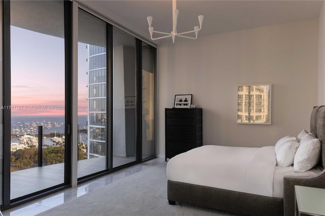 bedroom featuring tile patterned floors, a view of city, access to outside, and an inviting chandelier