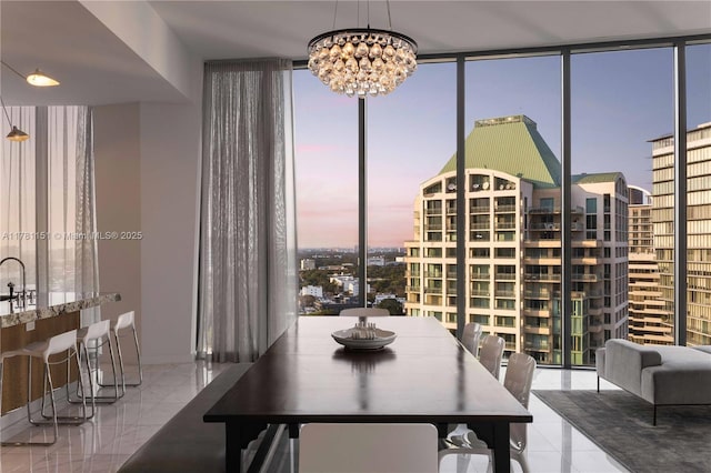dining room featuring a view of city, a notable chandelier, and floor to ceiling windows