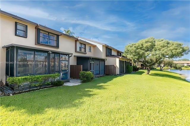 3950 Cocoplum Cir Unit F, Coconut Creek, FL 33063 - rear view of house with stucco siding, a yard, and a water view