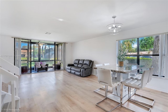 3950 Cocoplum Cir Unit F, Coconut Creek, FL 33063 - dining area with light wood-style flooring and a chandelier