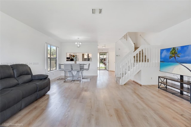 3950 Cocoplum Cir Unit F, Coconut Creek, FL 33063 - living room with wood finished floors, stairway, a chandelier, and baseboards