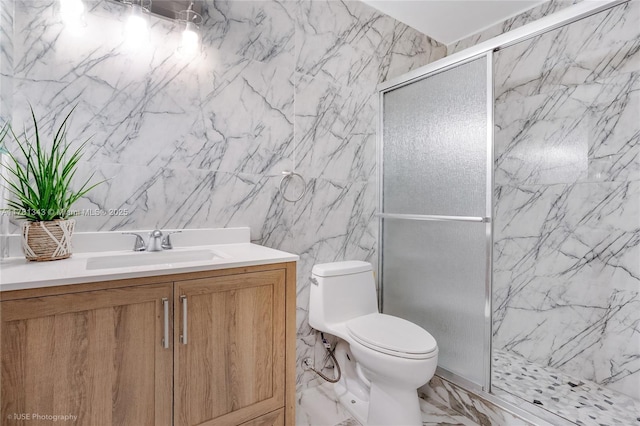 3950 Cocoplum Cir Unit F, Coconut Creek, FL 33063 - bathroom featuring a marble finish shower, vanity, toilet, marble finish floors, and tile walls