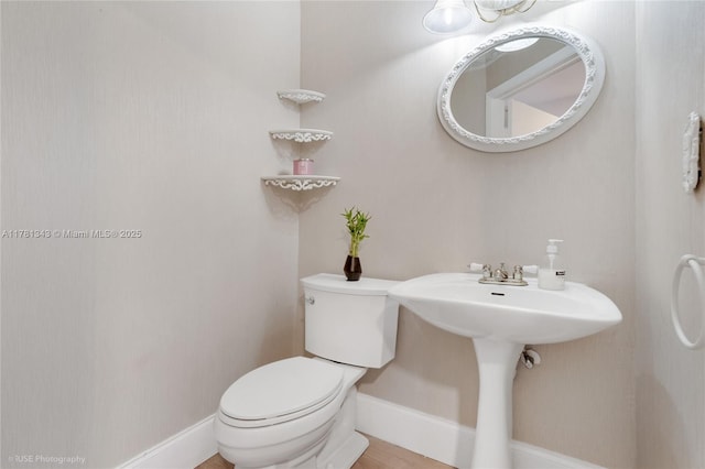 3950 Cocoplum Cir Unit F, Coconut Creek, FL 33063 - bathroom featuring toilet, baseboards, and a sink