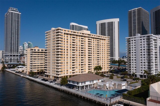 view of property with a water view and a city view